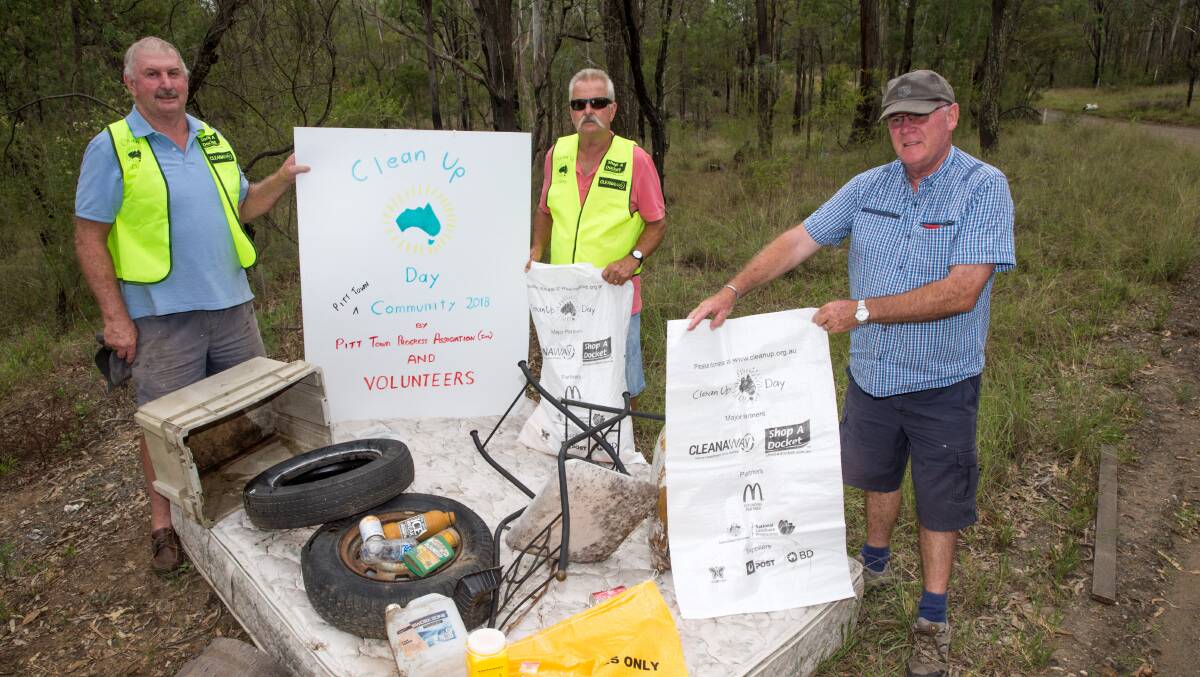 Pitt Town residents Peter Ryan, Steve Brown and Kevin O'Connor found this collection of rubbish in about two minutes on a trail road near the Pitt Town Sports Club. Picture: Geoff Jones