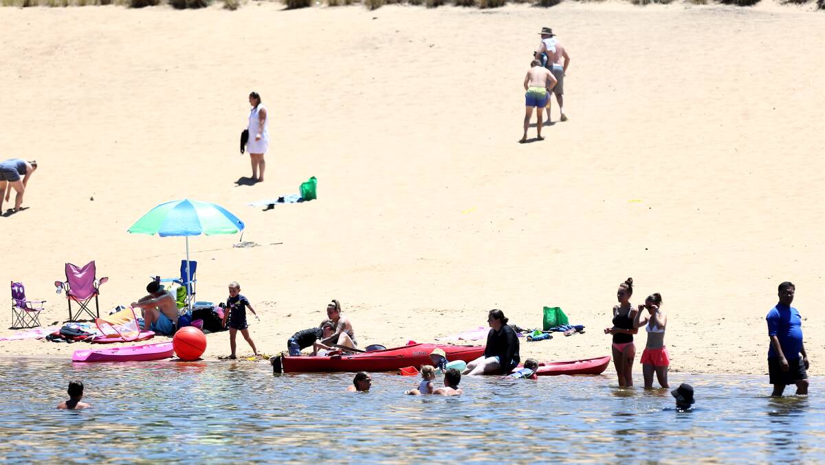 People cool off at Macquarie Park on Saturday, January 20, when the maximum temperature peaked at just over 40 degrees. Picture: Geoff Jones