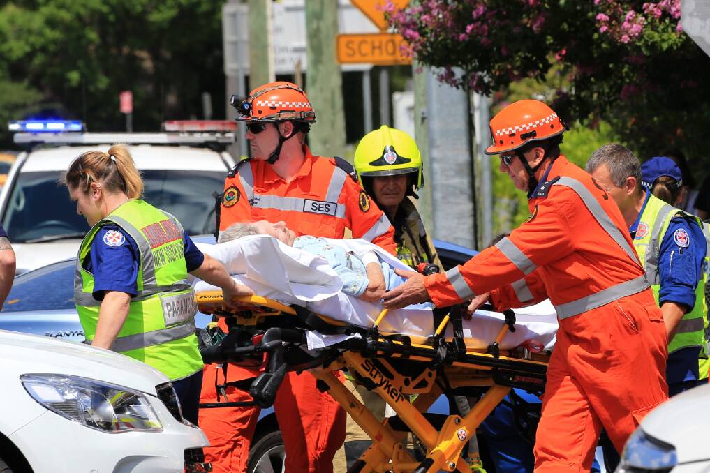 Treated: Emergency services crew assist the elderly patient involved in the motor vehicle collision in Richmond. Picture: Geoff Jones.