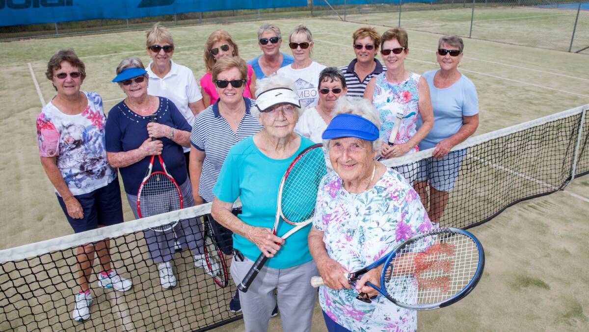 Marcia McMahon and Lynnette Nevell with the group of women who they play tennis with each week. Picture: Geoff Jones