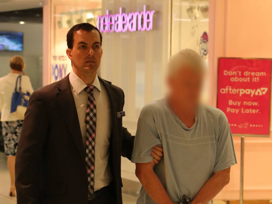The man is escorted through Sydney airport by detectives. Picture: NSW Police.