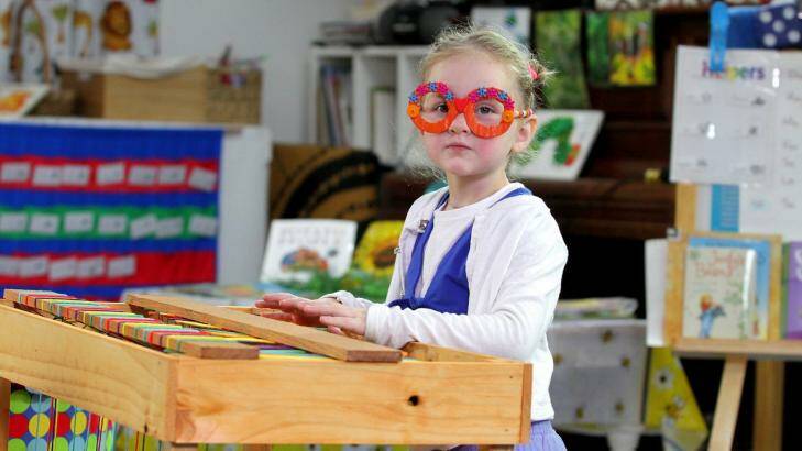 Caitlin Audibert, 4, from Brighton, plays the recycled keyboard. Photo: Michelle Smith