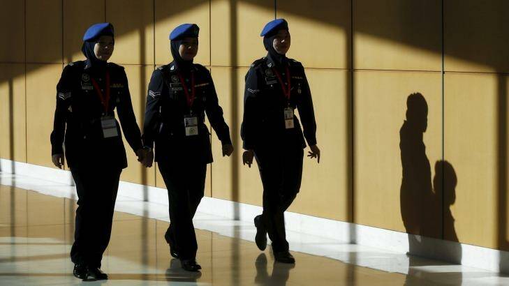 Police walk at the 26th ASEAN Summit in Kuala Lumpur, Malaysia.  Photo: Olivia Harris