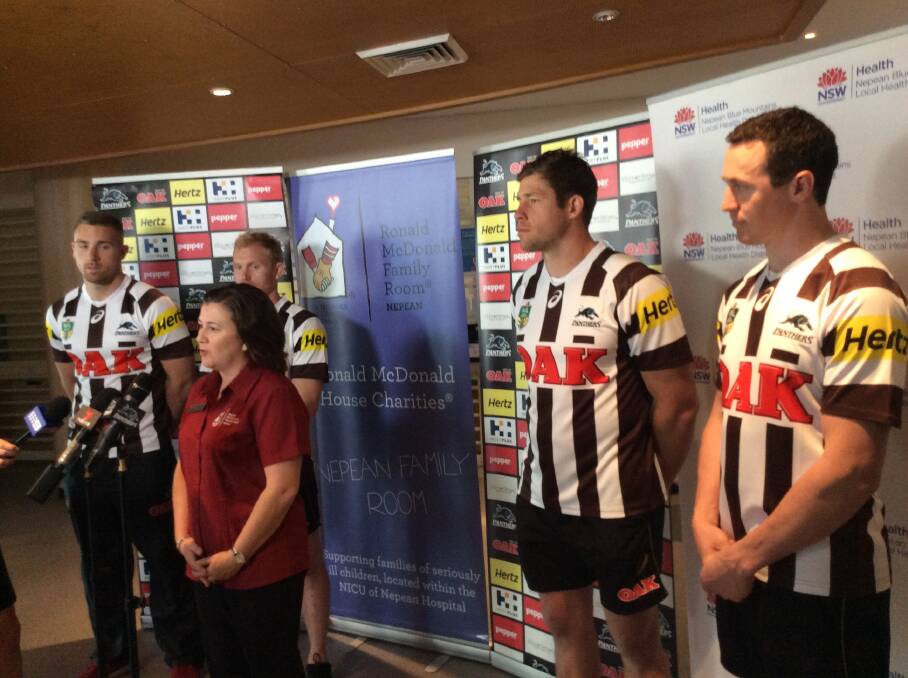 Show of support: Nepean Family Room Co-ordinator Meagan Preston (centre) with Panthers players Bryce Cartwright, Peter Wallace, Jeremy Latimore and David Simmons, who are modelling the heritage jersey for their round 20 clash. 