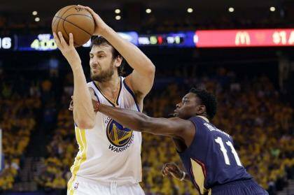 Central performer: Golden State Warriors centre Andrew Bogut  grabs a rebound next to New Orleans Pelicans guard Jrue Holiday. Photo: Marcio Jose Sanchez