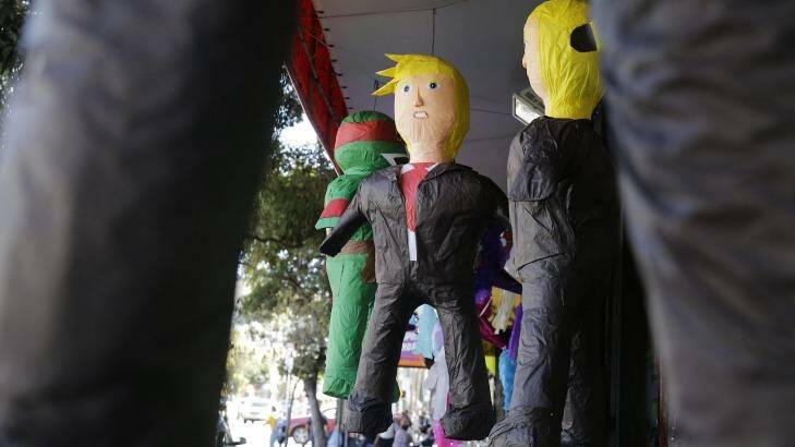 Pinatas in the likeness of Donald Trump hang for sale outside a Mission District discount store in San Francisco, California.  Photo: Eric Risberg