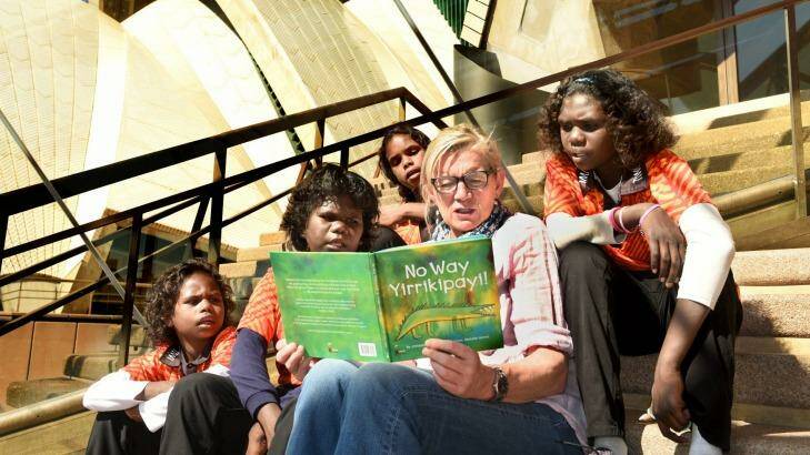 Ruby Lorenzo, Marguarita Palipuaminni, Barbara Darcy, and Michaeline from Milikapiti School reading with author Alison Lester with the book that they all contributed to. Photo: Steven Siewert
