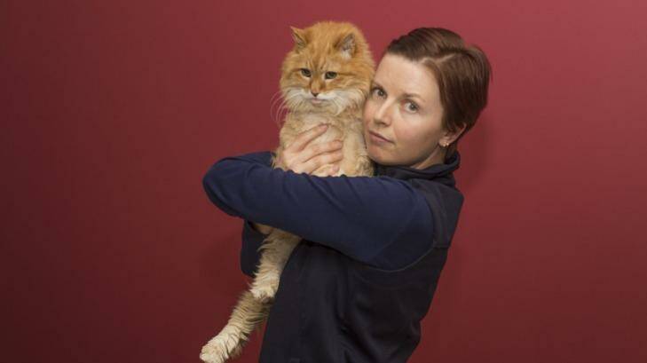 Thirsty cat: Canberra Cat Vet head nurse Leanne Kentwell with Oliver. Photo: Michelle Doherty