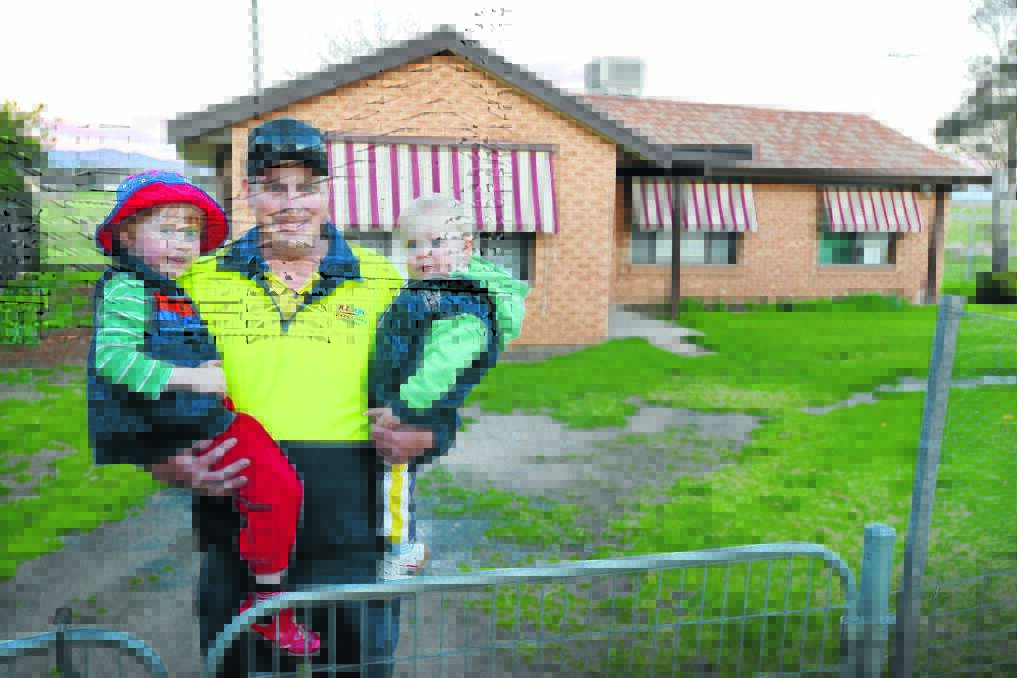 Tamworth father Cameron Adams, with sons Caleb, 3, and Charlie, 1, outside the home bought through the compassionate heart of the community. Mr Adams, who lost his wife to cancer in June, says he is overwhelmed by the gesture. 
