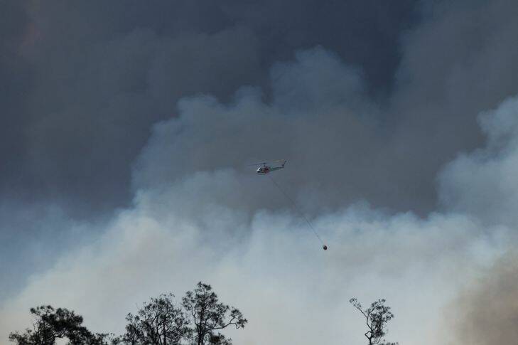 Masonite Rd Tomago bushfire. Pic shows a water bombing helicopter at work over the fire. Picture: Max Mason-Hubers MMH