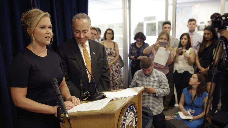 New York Sen. Chuck Schumer, second from right, and his distant cousin, Amy Schumer, left, speak during the Monday news conference in New York Photo: Seth Wenig