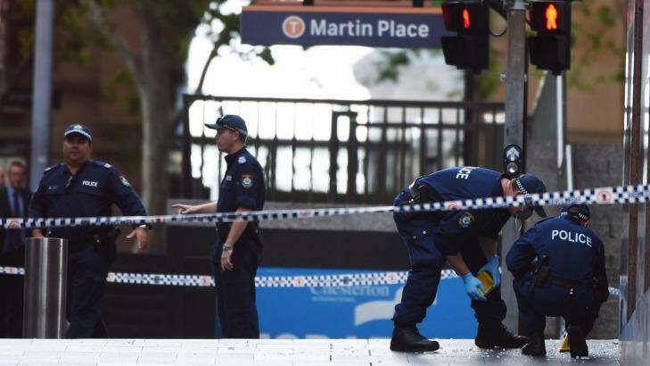 Seeking evidence: Forensic police officers mark out the Martin Place crime scene after the siege ended. Photo: Nick Moir