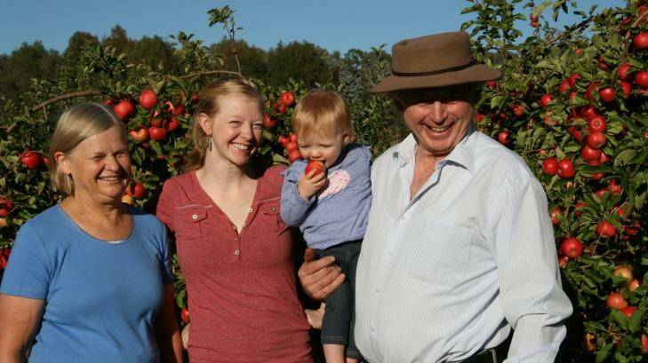 Owen Pidgeon's wife, Noreen, left, with their daughter, Lauren, and granddaughter Thea (1) at apple trees planted at Loriendale when Lauren was 1 week old. Photo: Supplied