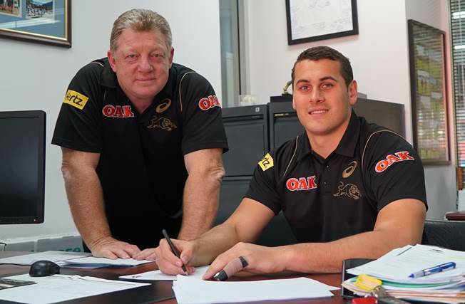 The dotted line: Reagan Campbell-Gillard puts pen to paper on a new deal with the Penrith Panthers, with general manager Phil Gould. 