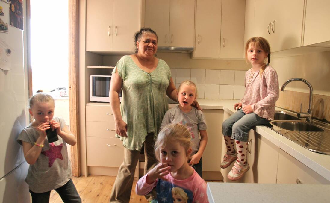 Spirits boosted: Jasmine Franklin with her grandchildren Eliza, 6, Nikki, 5, Lillian, 7, and Rachelle, 5, in the new kitchen Bunnings installed free of charge in their Freemans Reach home. Picture: Gene Ramirez.