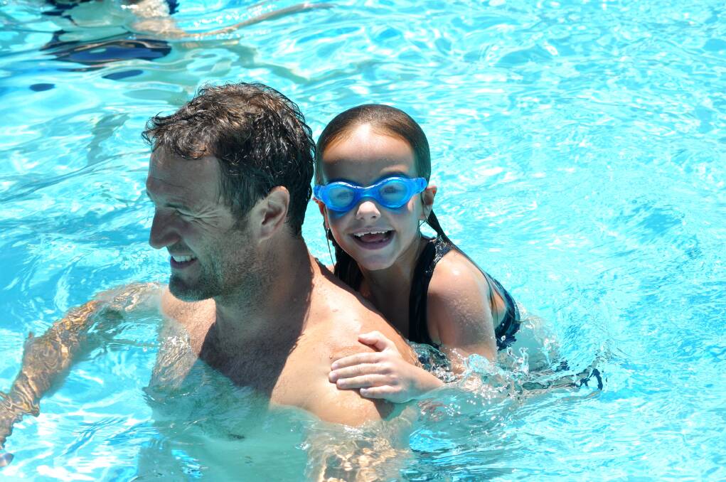 Halle Thomas, 6, hangs around with dad Mark in the main pool.