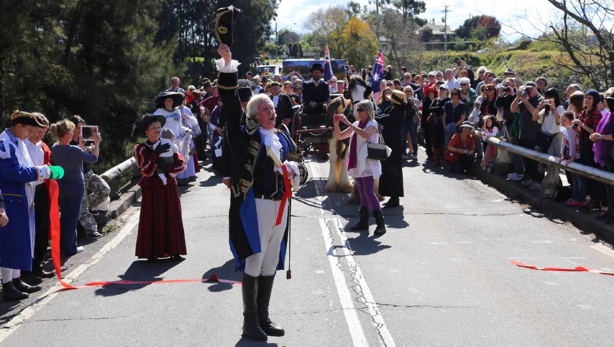 Town Crier (Graham Keating) leads the crowd across Windsor Bridge, to celebrate its 140th anniversary.