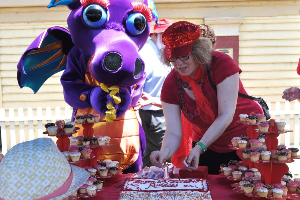 Birgit Walter helps Puddles cut her first birthday cake. Picture: Suzie Vlaming