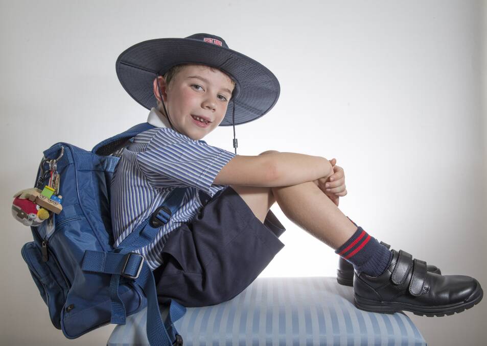 First day enthusiasm: Harrison Tolar in his new uniform. "He is obsessed with books and puzzles and can't wait to do them at school," his mum Heloise said. Picture: Geoff Jones