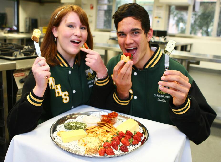 Nibbly nosh: Windsor High’s Year 12 students Rhiannon Dark and Lachlan Walker get stuck into some serious quality control ahead of the school’s Windsor Country Delights Producers’ Market this Saturday night.  Picture: Gary Warrick