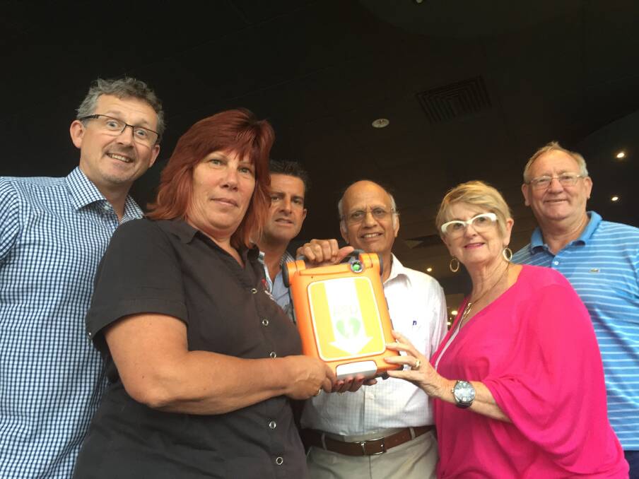 Little orange lifesaver: Andrew White and Sue Buckman from Defib your Club for Life, Dean Scheezel from Cardiac Science, Dr Ravi, Councillor Christine Paine and Richmond Rotary’s Barry Kennedy.
