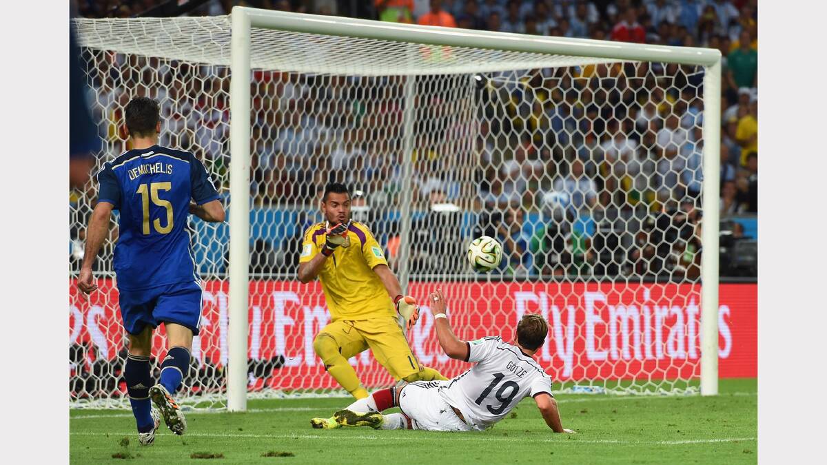 The moment: Mario Gotze, of Germany, slides the ball across the Argentine keeper to score the winner. Photo: Getty Images
