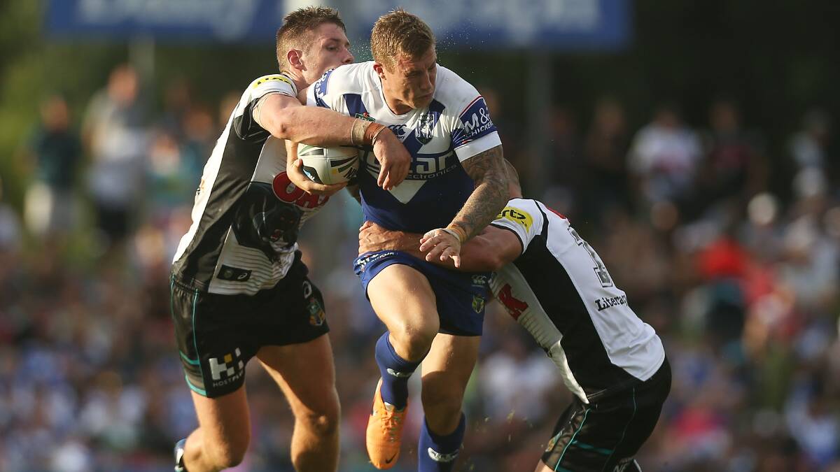 SYDNEY, AUSTRALIA - MARCH 22: Trent Hodkinson of the Bulldogs is tackled during the round three NRL match between the Penrith Panthers and the Canterbury-Bankstown Bulldogs at Sportingbet Stadium on March 22, 2014 in Sydney, Australia. (Photo by Mark Metcalfe/Getty Images)