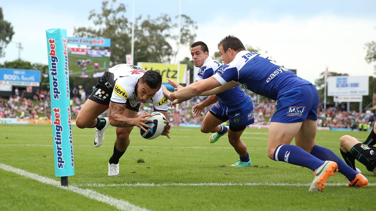SYDNEY, AUSTRALIA - MARCH 22: Dean Whare of the Panthers dives to score a try as he is challenged by Josh Morris of the Bulldogs during the round three NRL match between the Penrith Panthers and the Canterbury-Bankstown Bulldogs at Sportingbet Stadium on March 22, 2014 in Sydney, Australia. (Photo by Mark Metcalfe/Getty Images)