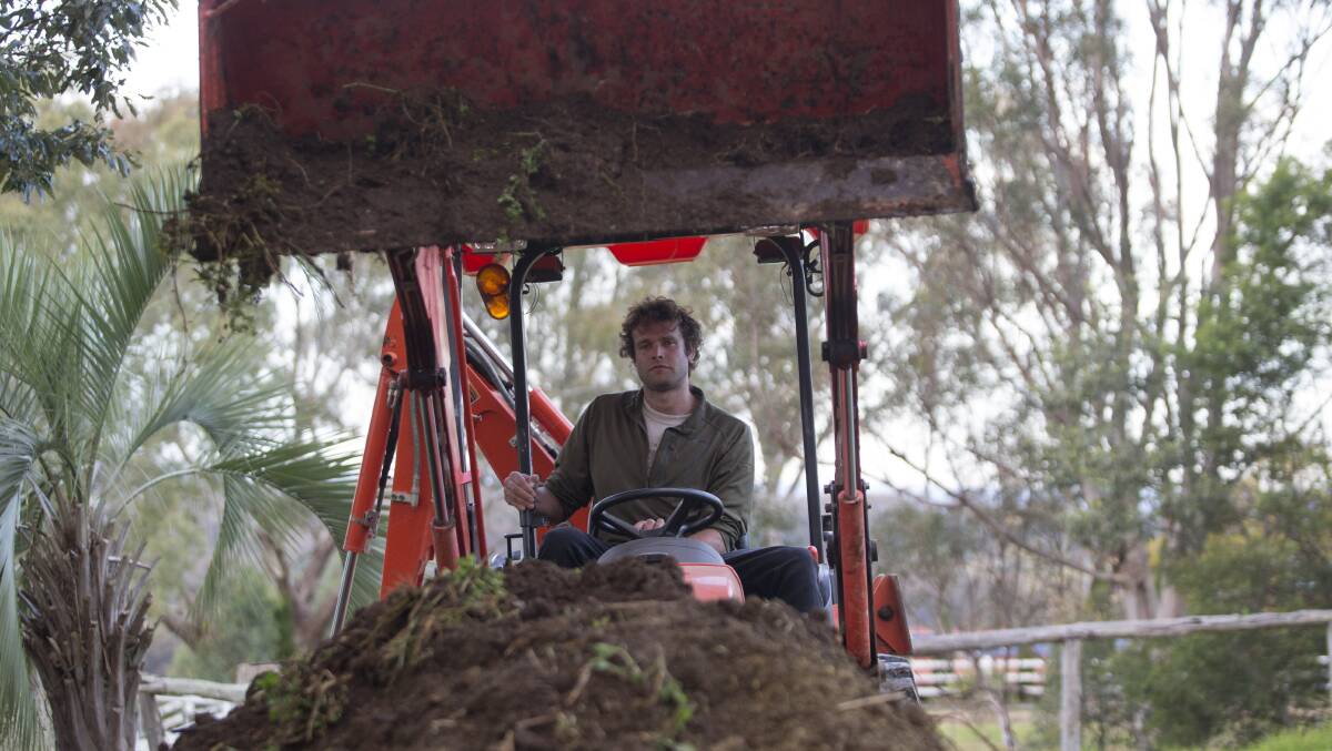 Not wasting a thing: Hawkesbury Hampers’ Aaron Brocken, working at Remony Farm, says food scraps, green waste and animal manure could be recycled for use on farms instead of going to landfill. Picture: Geoff Jones