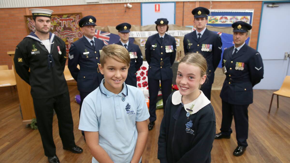 Honour and remembrance: Bligh Park Public School captains Jesse Falconer and Jasmine Brown with Able Seaman Leigh Gough, RAAF Sergeant Brad Withers, LAC Joel Williamson, LACW Kylie Barnes, Corporal Grant Clapton and LAC Ronald Schultz. Picture: Geoff Jones