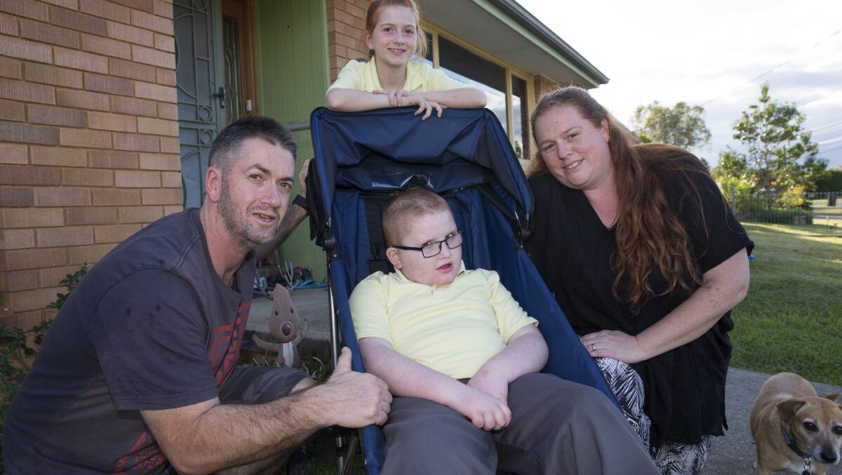 Going places: Jacob Currant with his parents, Ross and Georgina and sister, Maddie, in his new stroller, which makes long walks with his family possible. Picture: Geoff Jones