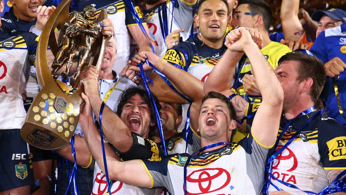 Lachlan Coote next to North Queensland Cowboys captain Johnathon Thurston as the team celebrated their NRL grand final win. Picture: Getty Images