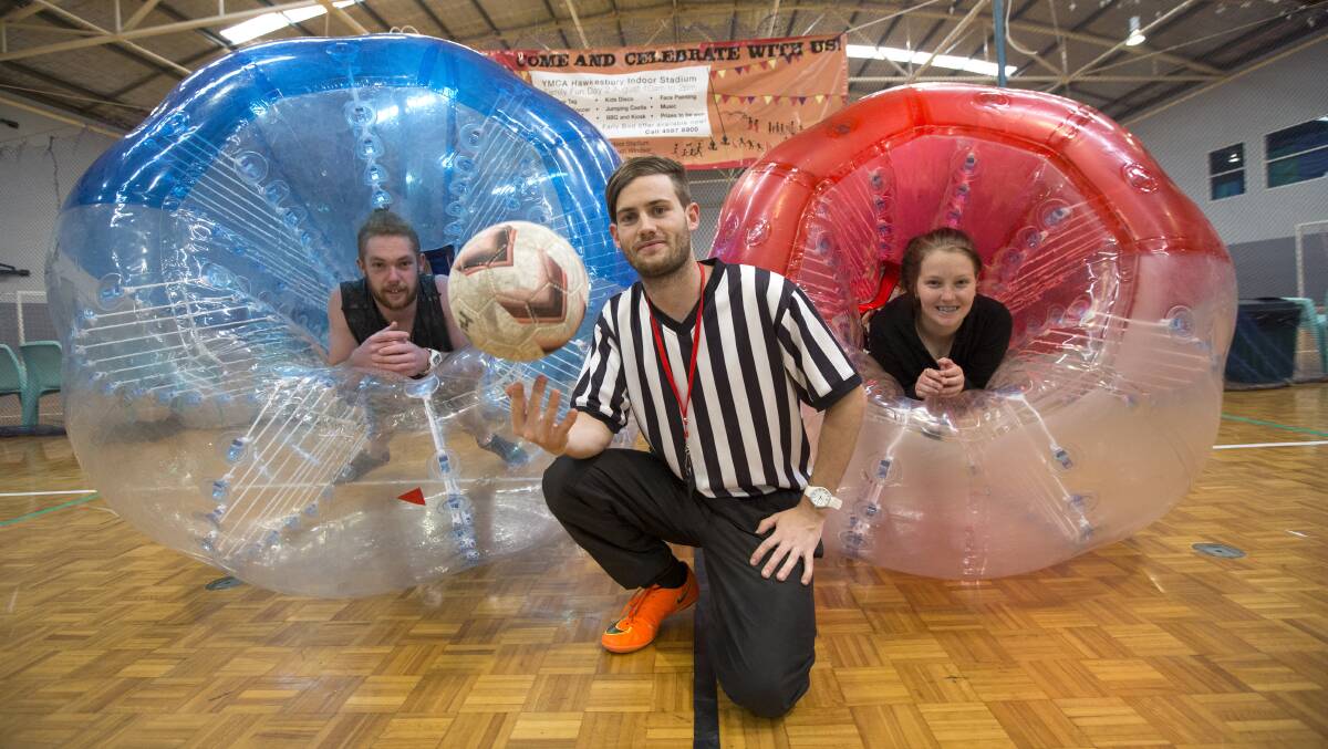 YMCA Sports Co-Ordinator Braydon Greentree, middle, with Keisah Donelly, right, and Zac Kirk with the bubble soccer zorbs. Picture: Geoff Jones.