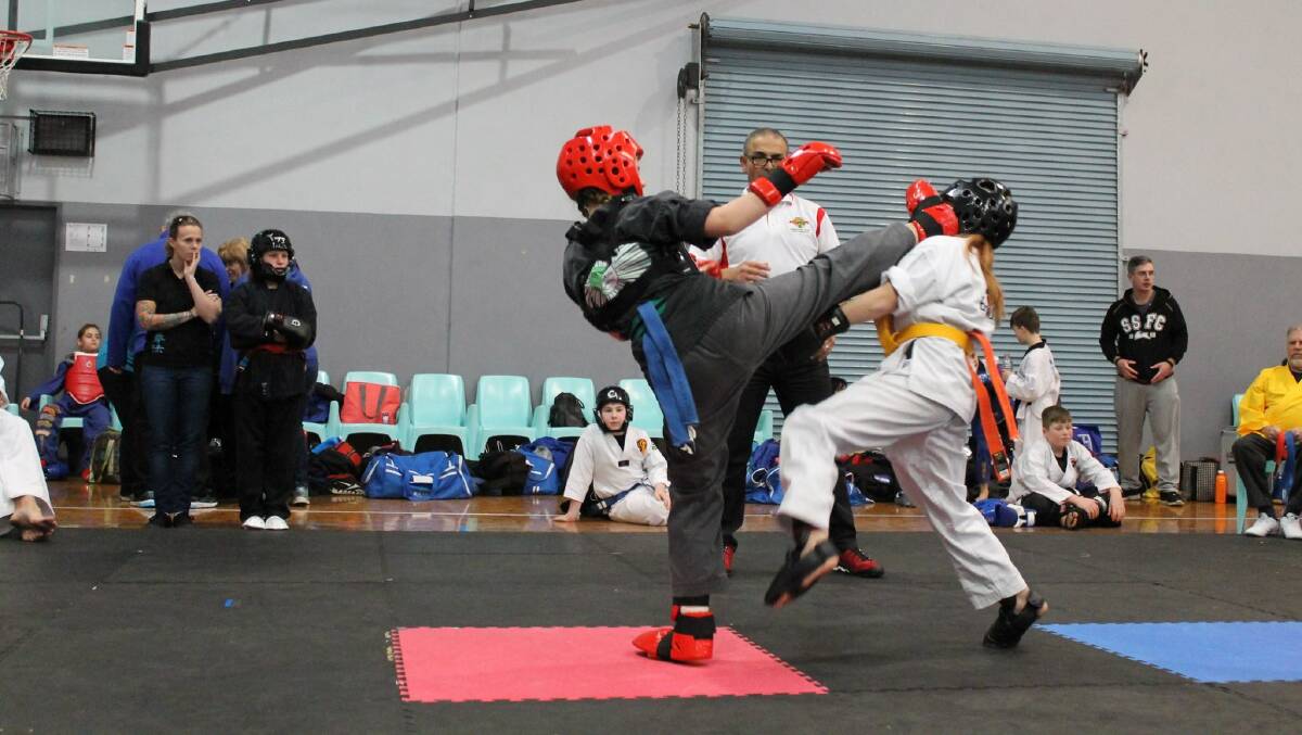 Destiny Martial Arts student Ella Yabsley delivering a kick to her opponent's head. Picture: Supplied