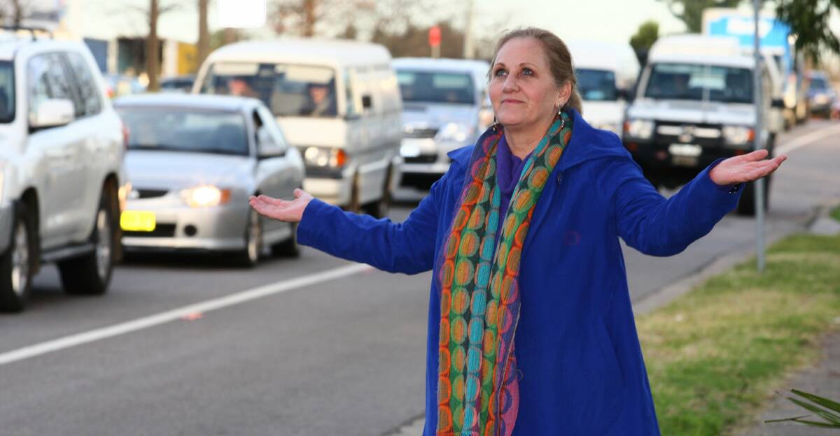 Hawkesbury councillor Mary Lyons-Buckett next to slow moving Hawkesbury traffic. Picture: Gary Warrick