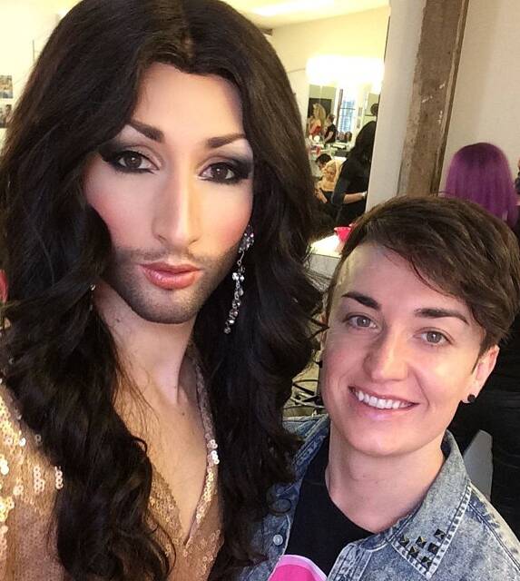 YES, SHE'S IN HEELS: Prada Clutch, as Conchita Wurst,
with her boyfriend-manager . . . and makeup artist, Gavin
Morris.