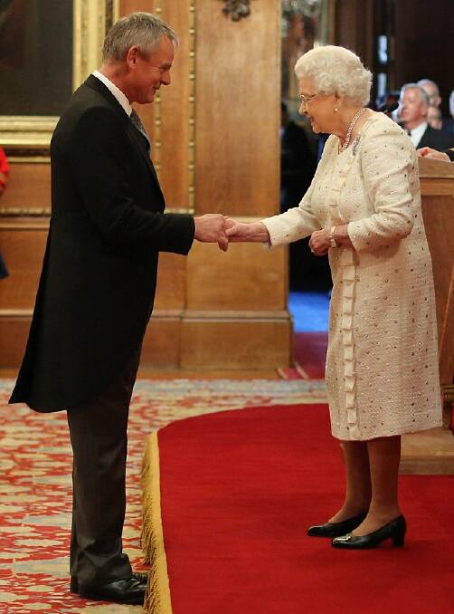 WITH THE QUEEN | Clunes gets an OBE for “services to drama, charity and the Dorset community” last year.