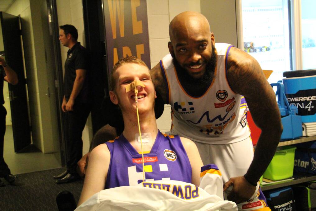 FIGHTER: Alex with his Sydney Kings basketball idol, US import Josh Powell. Powell was Alex's biggest supporter during his rehabilitation at Westmead.