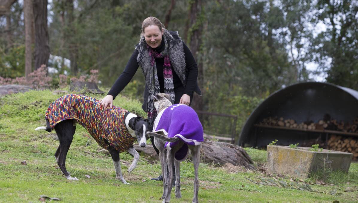 ANGERED: Peta Akester with her dogs Ivy (purple) and Bouncer at their East Kurrajong home. Picture: Geoff Jones .