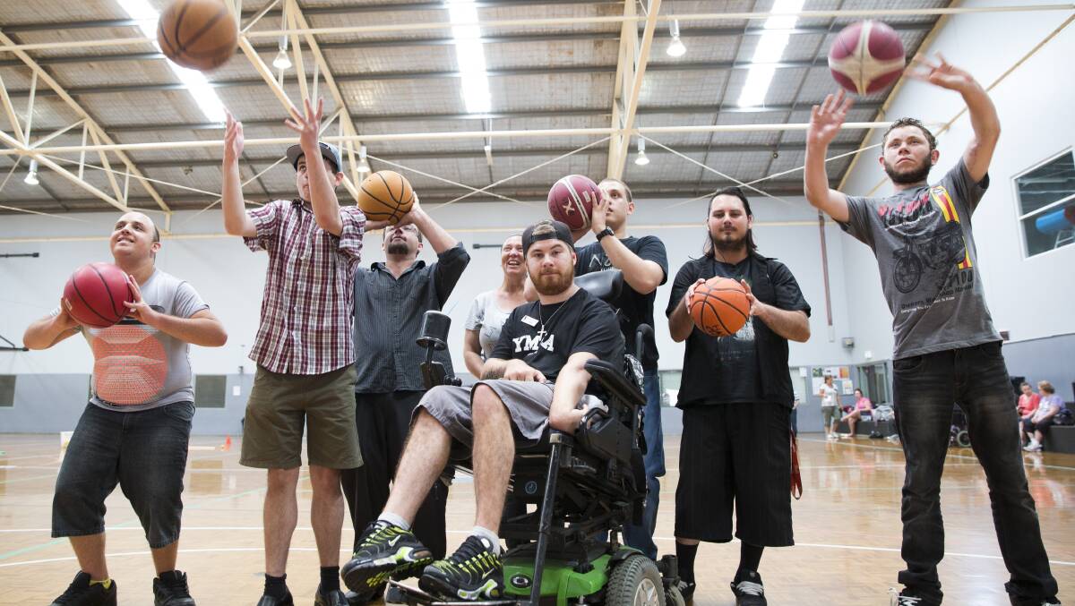GALA DAY: YMCA volunteer Justin Lampson (center) joins in the fun at a gala day for International Day of People with a Disability at Hawkesbury Indoor Stadium. Picture: Geoff Jones 