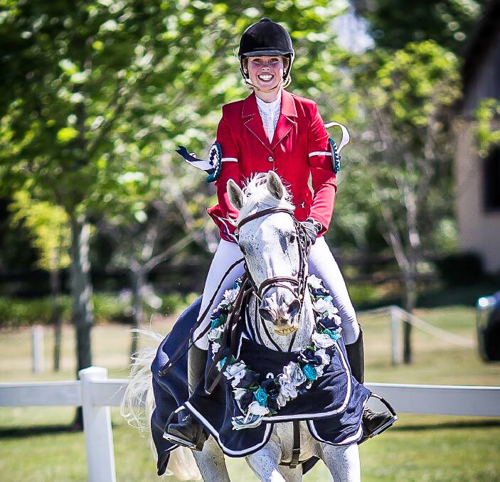 WINNING SMILE: Charlie Kinder on her horse Merry after winning first and third in the junior final at the Showcase of Showjumping event in Richmond last weekend. Picture: Stephen Mowbray