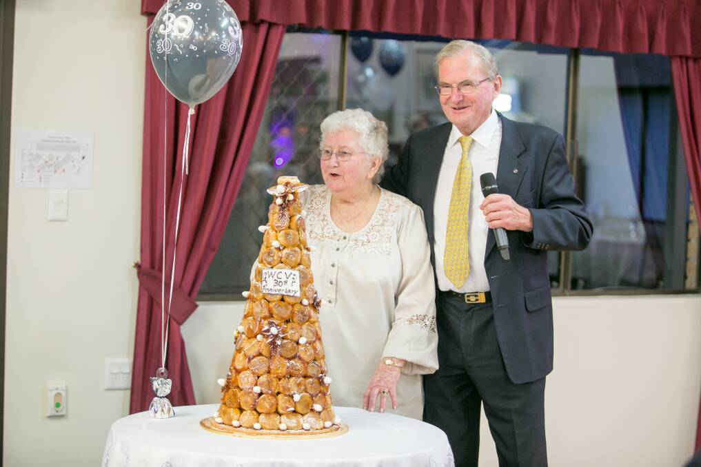 Windsor Country Village resident of 28 years, Anne Graham, cutting the cake with village manager Philip Edmonds.