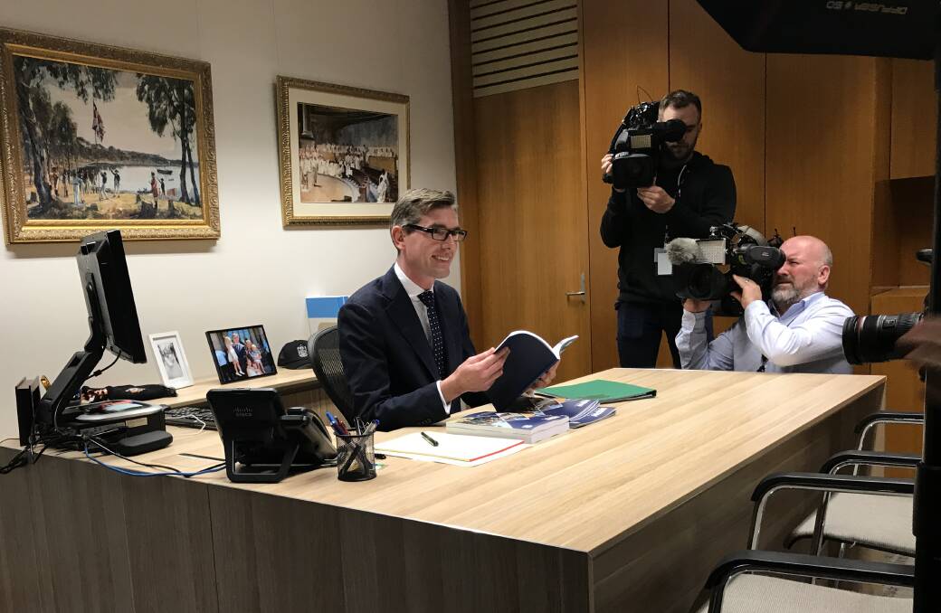 Member for Hawkesbury and NSW Treasurer Dominic Perrottet in his ministerial office with the papers for the 2017-18 NSW Budget. Picture: Supplied