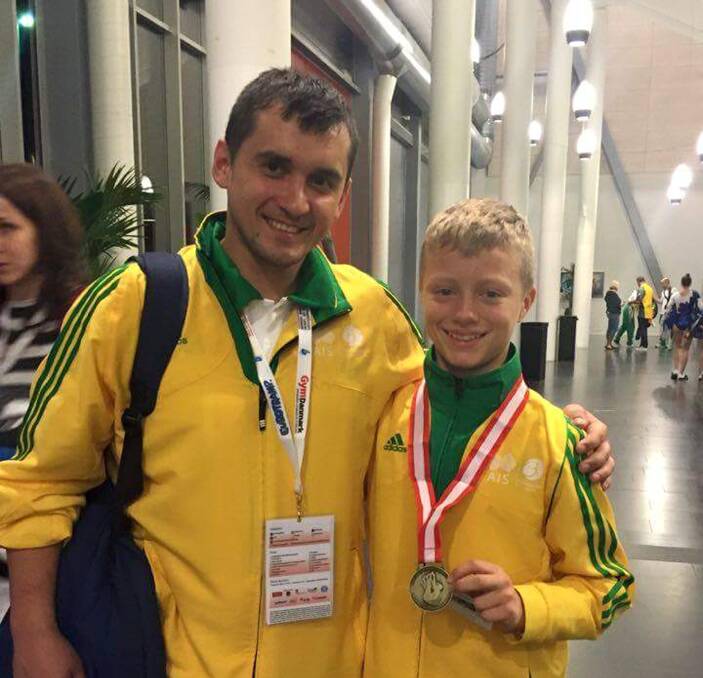 IMPRESSIVE: Dzmitry Kachan and Ethan McGuinness, with his gold medal he won at the world championships. Picture: Supplied