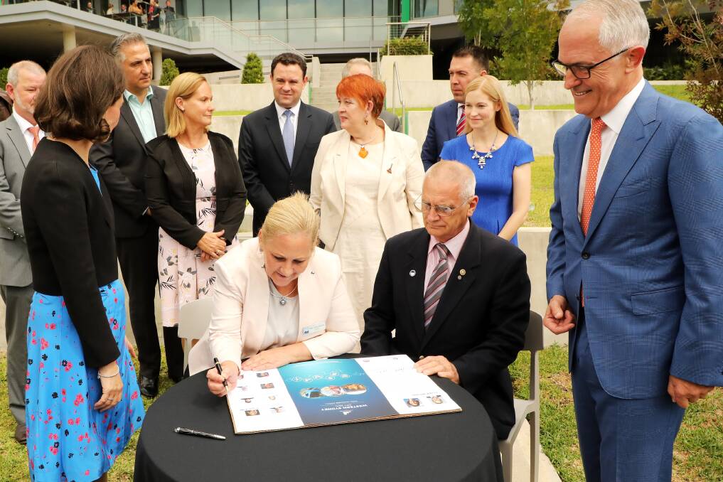 Hawkesbury Mayor Mary Lyons-Buckett signs her name on the Western Sydney City Deal. Picture: Supplied
