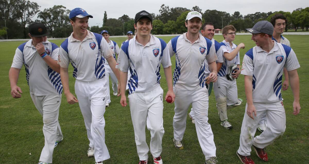 FUN: Bligh Park player Mark Walsh, black cap, leaves the field flanked by his team mates after a spectacular effort, including four wickets in five balls. Picture: Geoff Jones