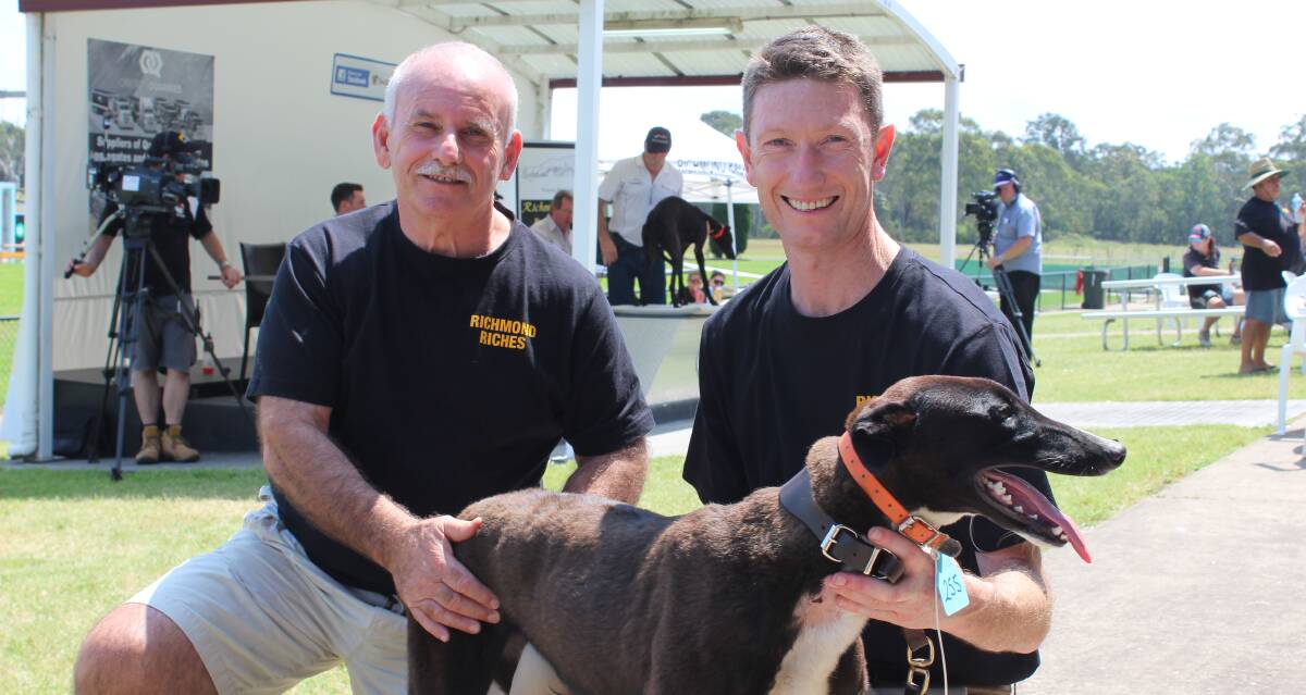 AUCTION: Richmond Race Club committee member Mario Abela and general manager Brad Adam display one of the pups up for auction. Picture: Conor Hickey