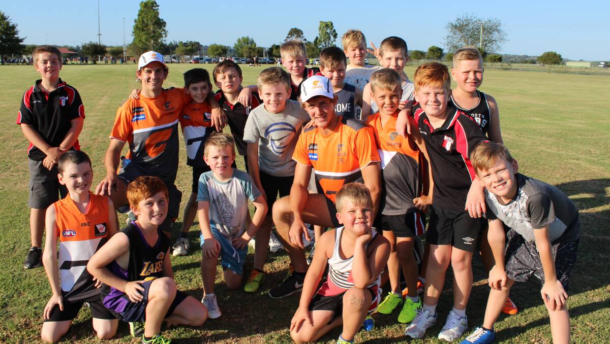 GWS Giants players Zach Sproule and Harry Perryman with some of the Hawkesbury Saints juniors. Picture: Conor Hickey
