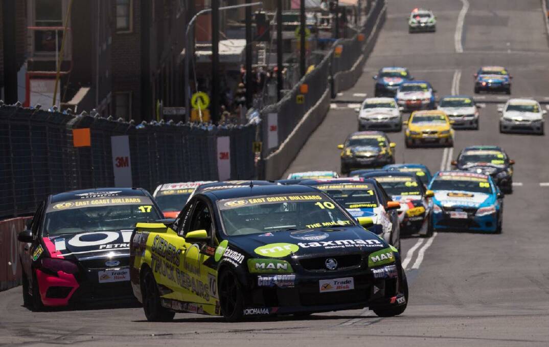 Mick Sieders leads the pack into a corner during a race in the V8 Utes series in 2017. His car has "The Mullet" printed on it, because of his trademark hairstyle. Picture: Rhys Vandersyde