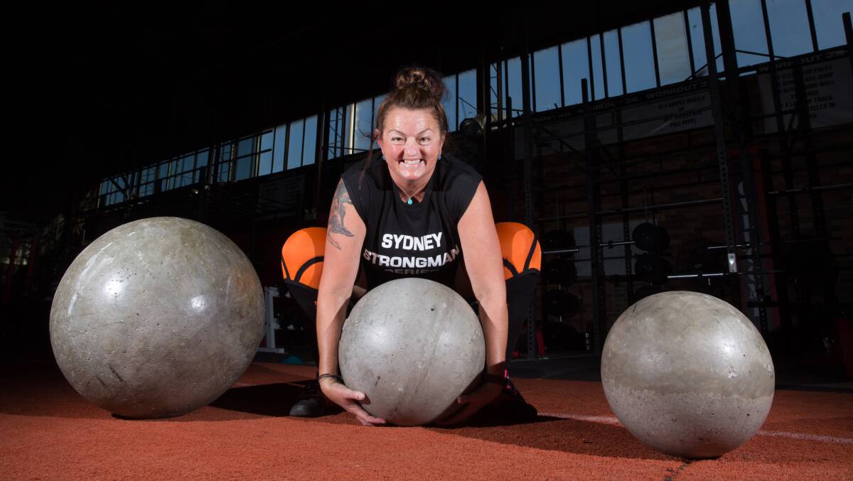 POWER: Tammy Wynen shows off her lift of an Atlas stone at the gym where she trains in North Richmond. Picture: Geoff Jones